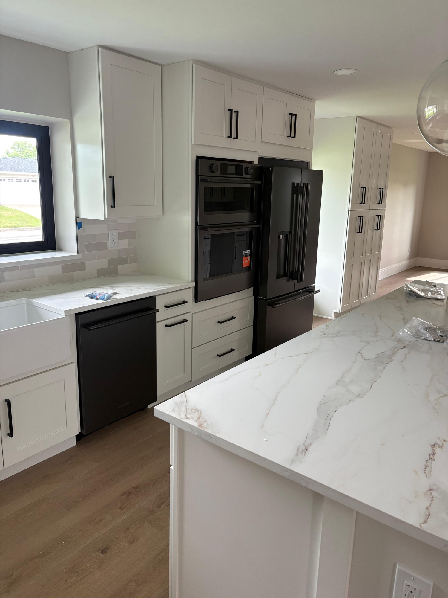 Full black stainless kitchen suite: dishwasher, double wall oven, and French door refrigerator