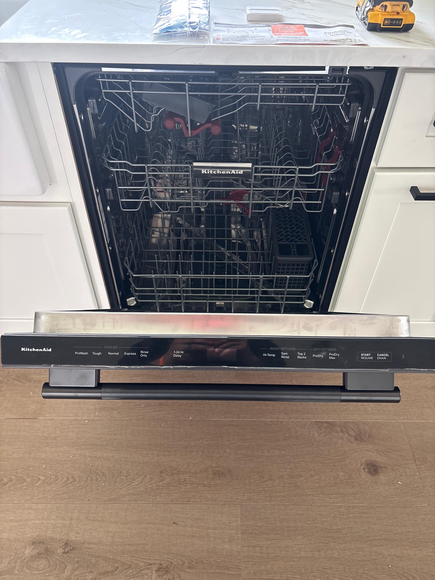 KitchenAid dishwasher installation, door open showing interior