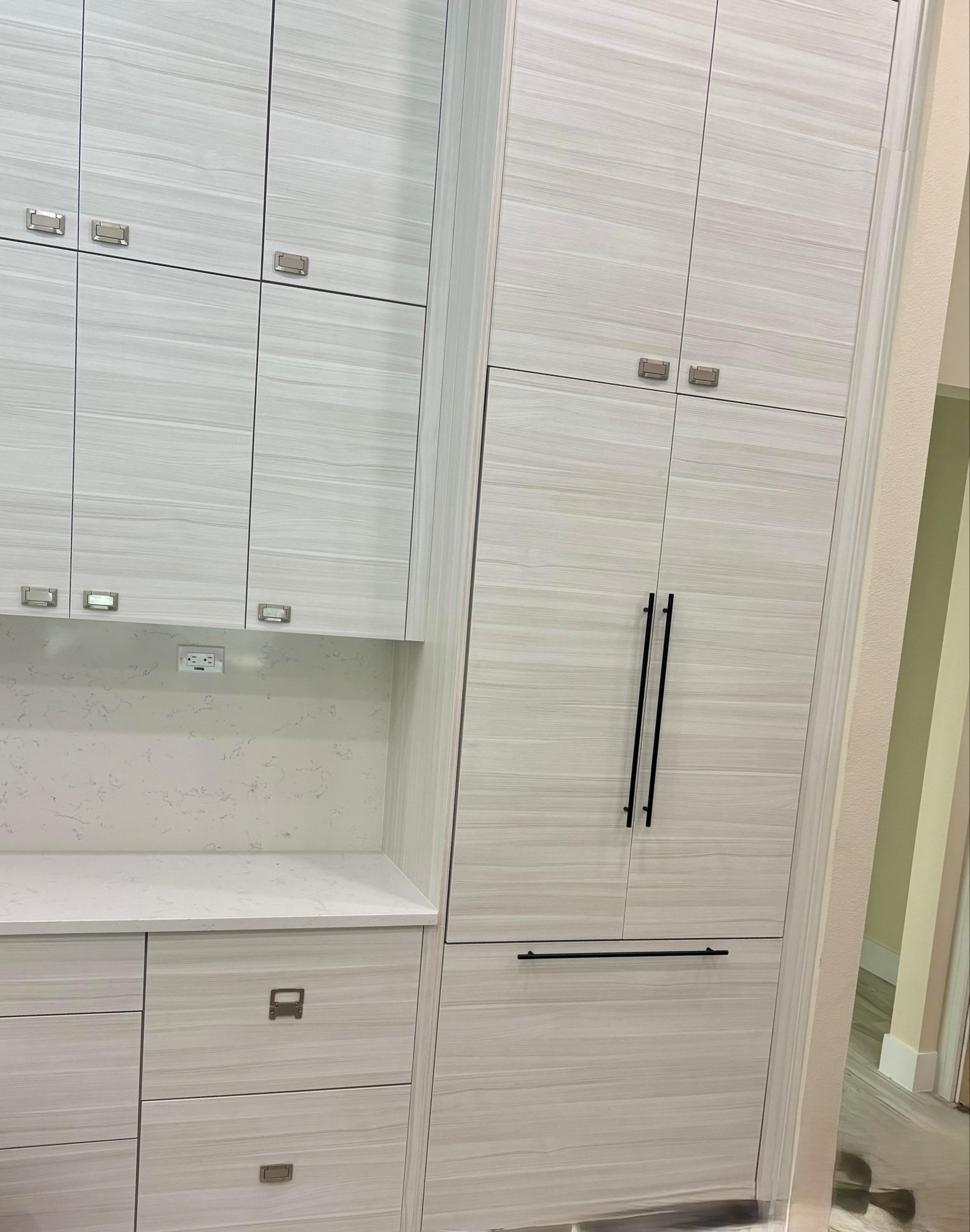 Panel-ready built-in refrigerator flush with custom two-tone cabinetry