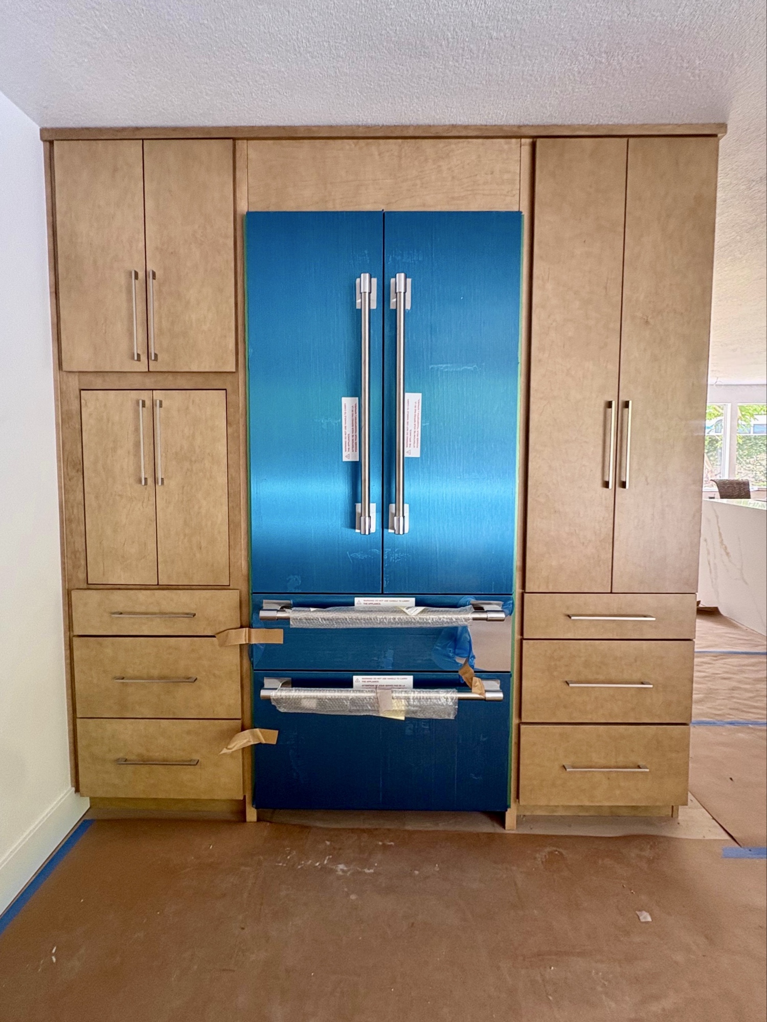 Panel-ready French door refrigerator flanked by custom cabinetry