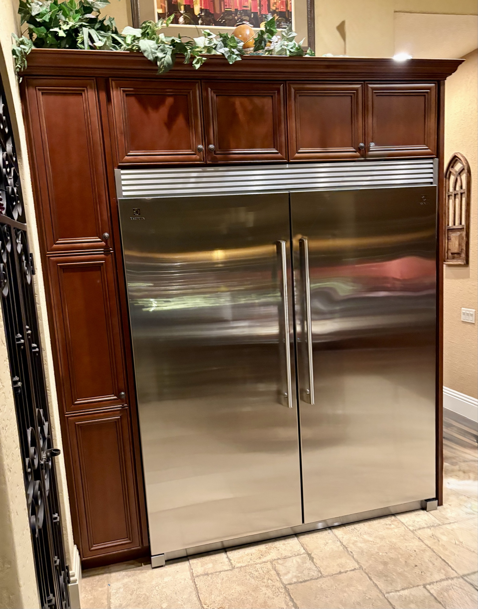 Large stainless built-in refrigerator in custom cherry cabinetry