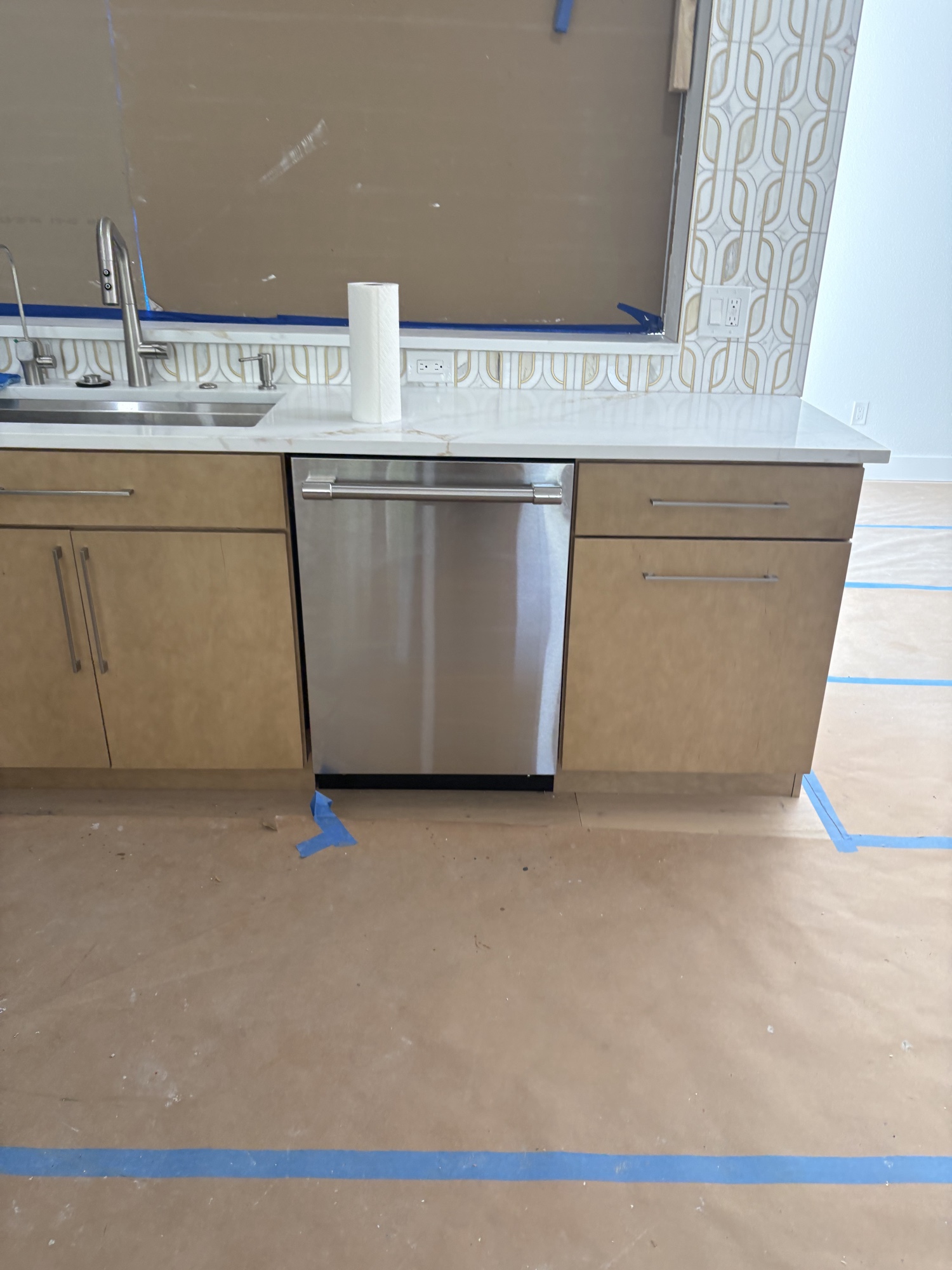 Stainless dishwasher in modern kitchen under construction