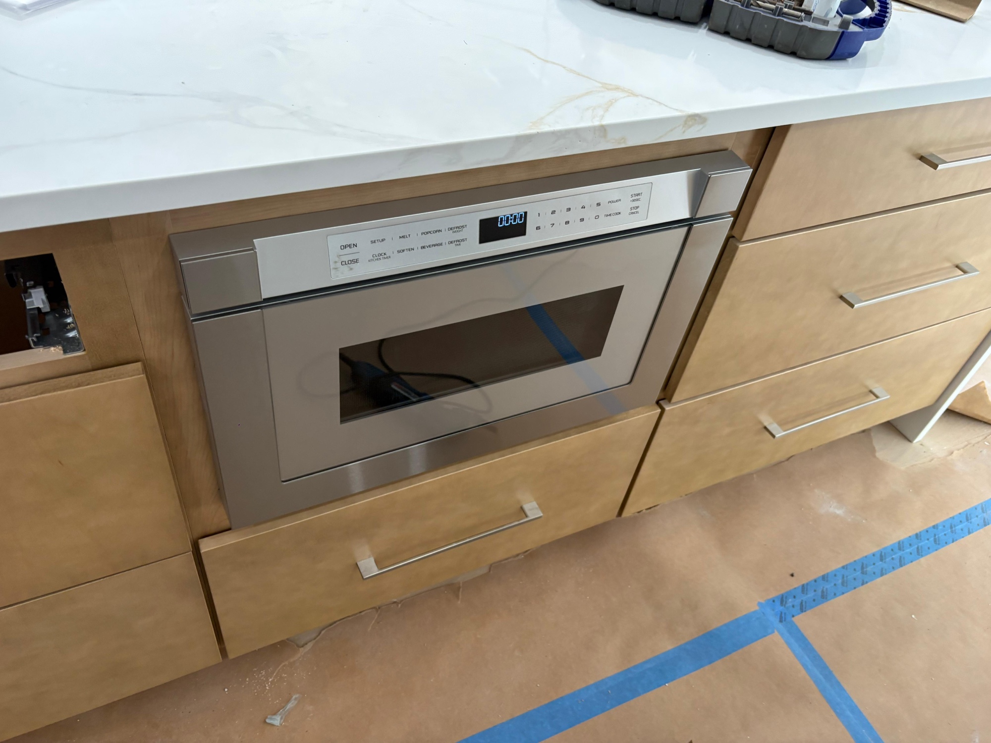 Drawer microwave built into kitchen island under quartz countertop